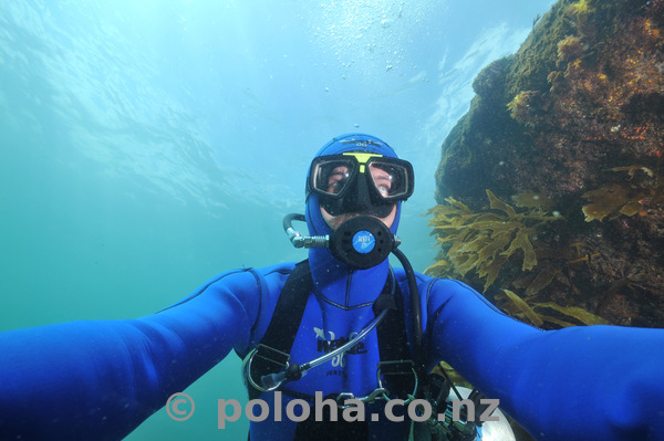 Sidemount scuba diver descending